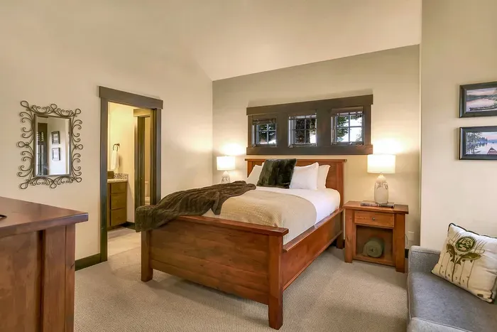 Upstairs guest room with a queen bed and plenty of natural light.