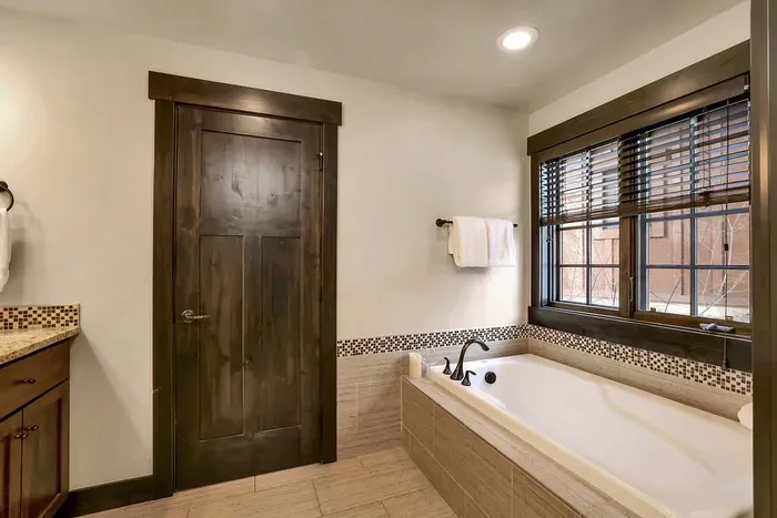 Primary ensuite bath with a big soaker tub for post-ski muscle recovery