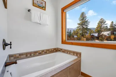 Unwind in the primary ensuite with a long soak after a full day outside.