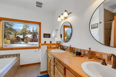 Spacious primary bath with separate shower and soaking tub for easy group mornings.