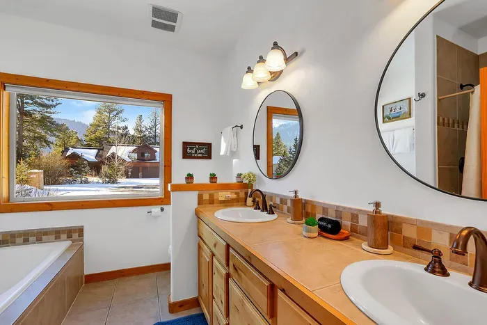 Spacious primary bath with separate shower and soaking tub for easy group mornings.
