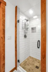 The loft bathroom offers convenience and privacy, complete with a walk-in shower and stylish amenities