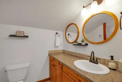 Indulge in the loft's ensuite bathroom, featuring a spacious layout with modern fixtures, perfect for unwinding after a day of adventure