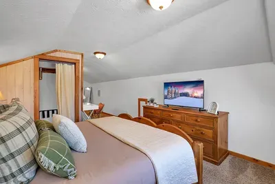 Loft suite with king bed, ensuite bath, and workspace—ideal for remote work or extra privacy.