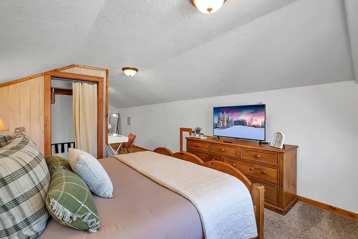 Loft suite with king bed, ensuite bath, and workspace—ideal for remote work or extra privacy.