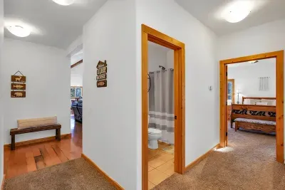 Back on the main floor, you'll find the primary suite, two guest bedrooms, and a full bathroom