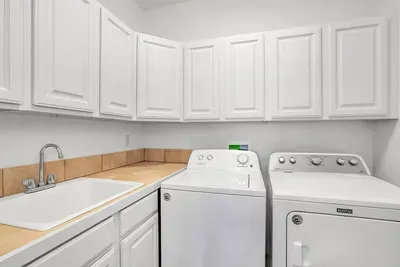 The large laundry room offers plenty of storage and space to drop gear, boots, and bags after a long day outside.