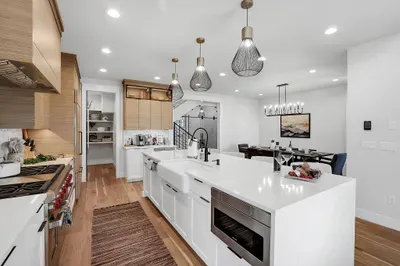 Elegant and Functional Design: The kitchen combines aesthetics with practicality, offering custom cabinetry, a spacious walk-in pantry, and a gas range for all your cooking needs.