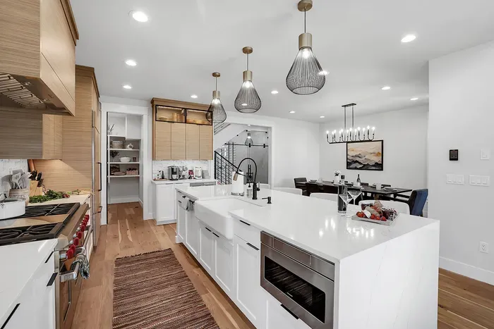 Elegant and Functional Design: The kitchen combines aesthetics with practicality, offering custom cabinetry, a spacious walk-in pantry, and a gas range for all your cooking needs.