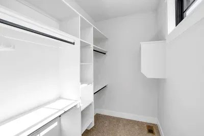 The upstairs suite features a generous walk-in closet, offering plenty of space