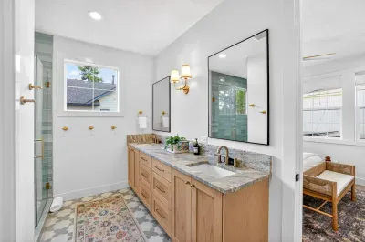 Ensuite bath with double vanity and walk-in tiled shower provides hotel-level comfort in a quiet, private retreat.