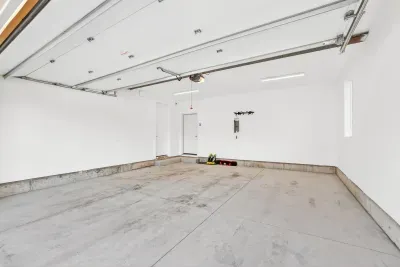 Attached two-car garage offers secure, weather-protected parking plus convenient storage for your boat gear, skis, and included kayak/SUP—making arrivals, departures, and daily adventures feel as seamless as a well-run inn.