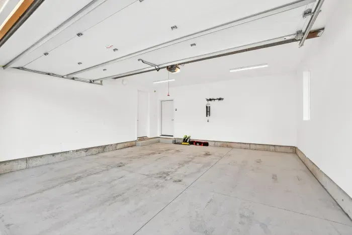 Attached two-car garage offers secure, weather-protected parking plus convenient storage for your boat gear, skis, and included kayak/SUP—making arrivals, departures, and daily adventures feel as seamless as a well-run inn.