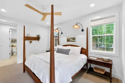 Vintage-inn touches, soft lighting, and a plush king mattress make this second main floor suite a quiet sanctuary just steps from the great room.