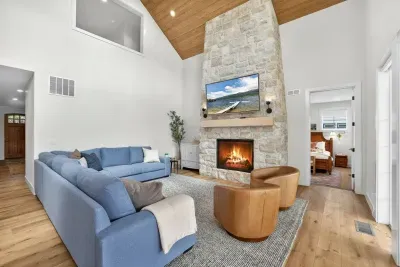 Main living area designed for slow mornings: coffee by the fire, kids on the rug with puzzles, and no rush to be anywhere at all.