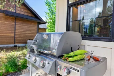 Fire up the Weber propane grill just off the great room and host effortless alfresco dinners, with the pickleball court and back lawn as the evening backdrop.