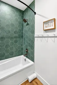 Clean, inn-inspired finishes and bright lighting give both upstairs baths a fresh, spa-adjacent feel, perfect for rinsing off after the lake or slopes.
