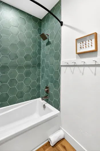 Clean, inn-inspired finishes and bright lighting give both upstairs baths a fresh, spa-adjacent feel, perfect for rinsing off after the lake or slopes.