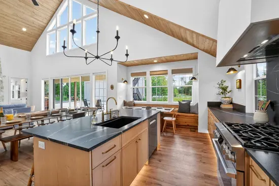 Fully equipped chef-friendly kitchen with gas range, stainless appliances, and room to prepare meals for up to 16 guests.
