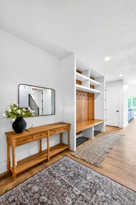 Large mudroom-style entry with hooks, benches, and storage keeps ski boots, life jackets, and outdoor gear organized.