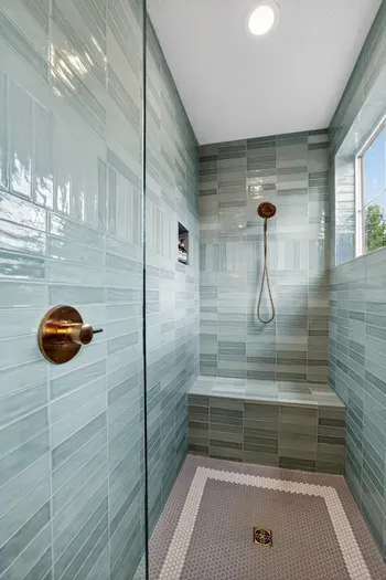 Each main-floor primary suite features a walk-in, spa-style tiled shower with glass enclosure and premium fixtures—an elevated, inn-worthy start and end to your day at the lake.