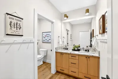 Two full bathrooms upstairs, each with dual vanities and a tub/shower combo, make busy mornings easy—multiple families can get ready at once without waiting in line.
