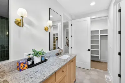 Thoughtful storage, bright lighting, and quality linens make this ensuite as functional as it is beautiful—perfect for couples settling in for an extended stay.