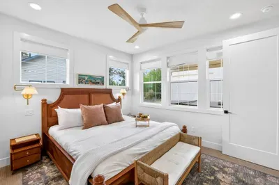 Primary bedroom features crisp linens, a king bed, and a calm, neutral palette to ensure a fantastic sleep.