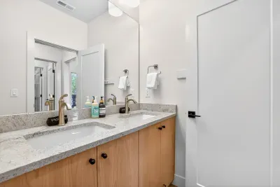 Quality towels, thoughtful storage, and uncluttered design ensure these shared bathrooms feel comfortable, refined, and easy to use even with a full house.