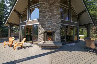 This contemporary dual-sided indoor/outdoor fireplace is one of our favorite features at Knotty Pines, a gorgeous feature to this spacious deck