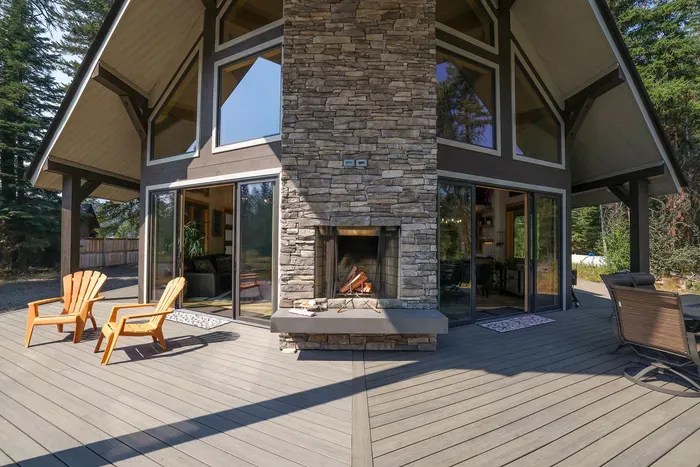 This contemporary dual-sided indoor/outdoor fireplace is one of our favorite features at Knotty Pines, a gorgeous feature to this spacious deck