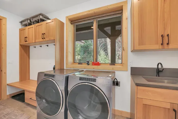 Right off the attached garage, the mudroom is such a luxurious addition! With built-in shelving for storing your gear, full-size front load Whirlpool washer/dryer, and a utility sink, your outdoor equipment can stay separate from the main house