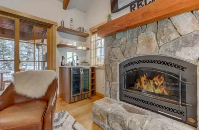 Relax after a day on the mountain in front of the fireplace with a bottle of chilled wine, made possible by your built-in wine fridge