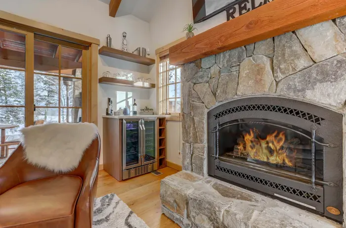 Relax after a day on the mountain in front of the fireplace with a bottle of chilled wine, made possible by your built-in wine fridge