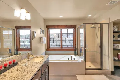 Spa‑style primary bath with soaking tub and walk‑in shower for serious recovery