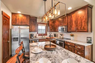 Bright, modern kitchen fully stocked for real cooking, not just takeout.