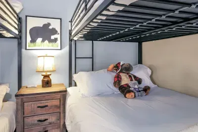 Adventure Awaits Right at Home: This ensuite is a mini getaway, where kids can dive into their own world of imagination—bunk beds and games galore for endless fun. High chair and pack ’n play for stress‑free travel with little ones.