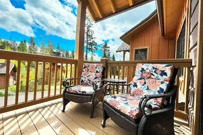 Sip and Savor the View: Enjoy your morning coffee on the covered balcony, where the cozy seating area invites you to relax and soak in the beauty of summer mornings