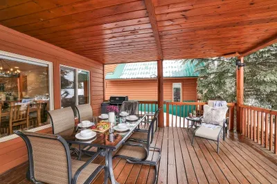 Bring dinner outside and stay for sunset over the treetops on the covered deck.