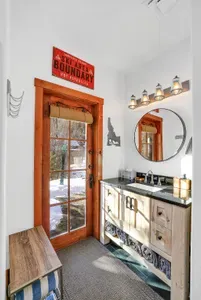 Daylight-level bathroom with quick-change access straight to the hot tub and trail—no dripping gear through the whole Lair.