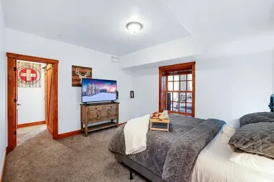 Spacious guest room with a queen bed, walk-in closet, and smart TV—perfect for the friend who always “accidentally” stays one more night.