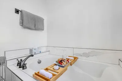 Deep soaking tub in the primary suite—built for long, quiet soaks after loud, fast days on the mountain.