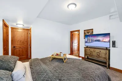 Crash in comfort: a real queen bed, room to spread out, and a smart TV for winding down after last chair.