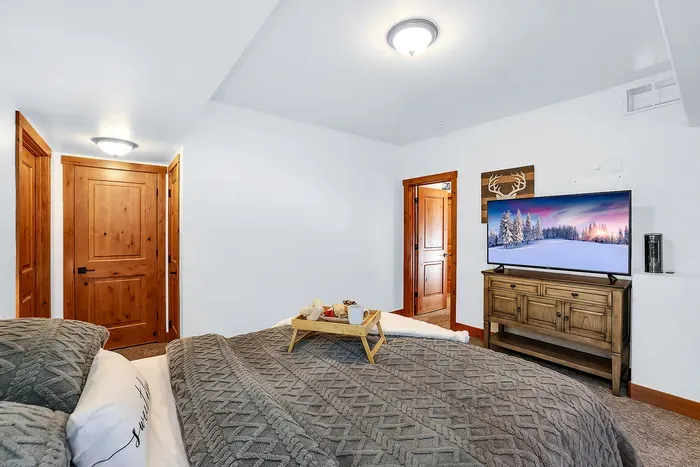 Crash in comfort: a real queen bed, room to spread out, and a smart TV for winding down after last chair.