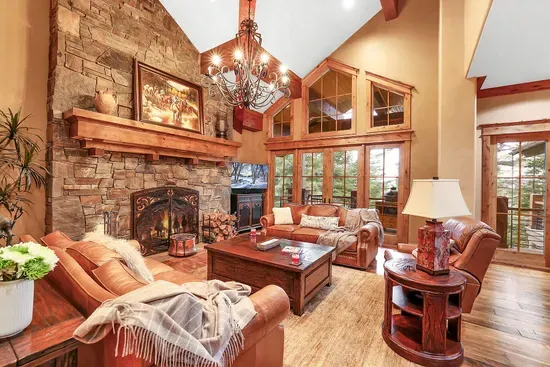 Timber and stone, floor-to-ceiling views, and a wood‑burning hearth. The Great Room is the heart of the lodge and the start of every great day