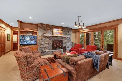 Game on inside, stars outside—the family room flows to the lower patio for easy night air between refills