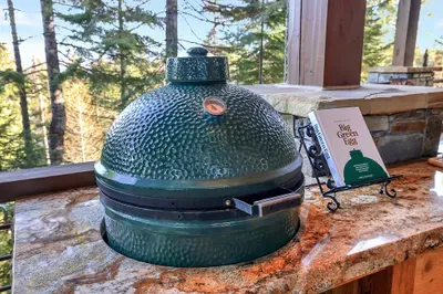 The Big Green Egg holds steady heat for slow-smoked brisket or seared steaks—fire it up and let the mountain air season everything