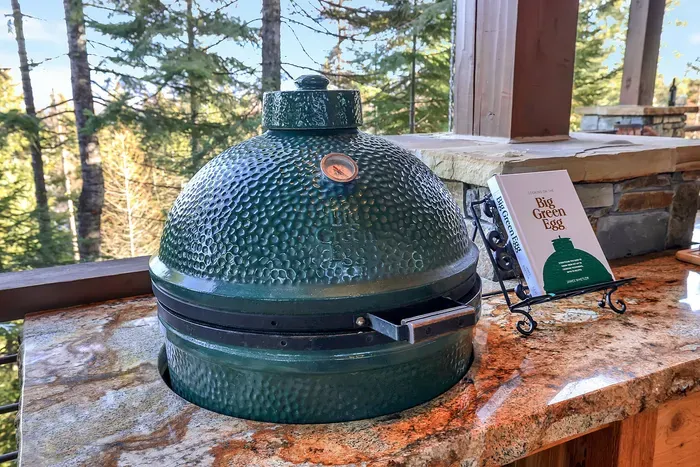 The Big Green Egg holds steady heat for slow-smoked brisket or seared steaks—fire it up and let the mountain air season everything