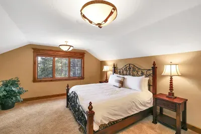 Quiet, restorative, and refined: a king bed under timber, a dual vanity for easy routines, and a shower/tub combo that works for everyone