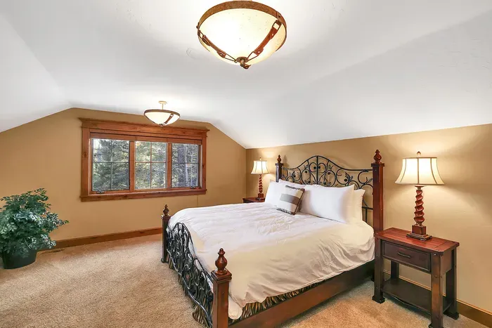 Quiet, restorative, and refined: a king bed under timber, a dual vanity for easy routines, and a shower/tub combo that works for everyone